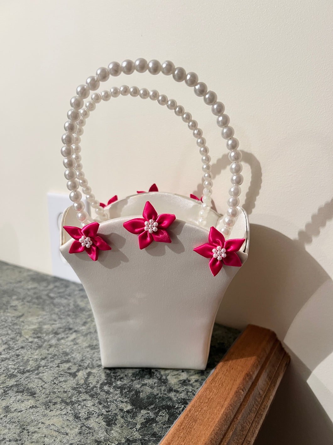 Ivory flower girl basket w/ pink flowers