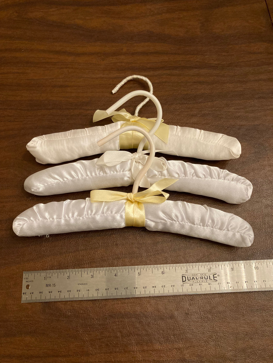 3 cloth hangers w ribbon 2 yellow & 1 white