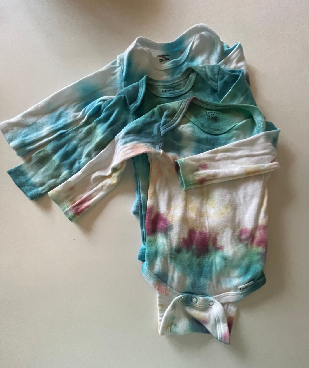 gerber long sleeved onesies, tye die - light - size 3-6 Months