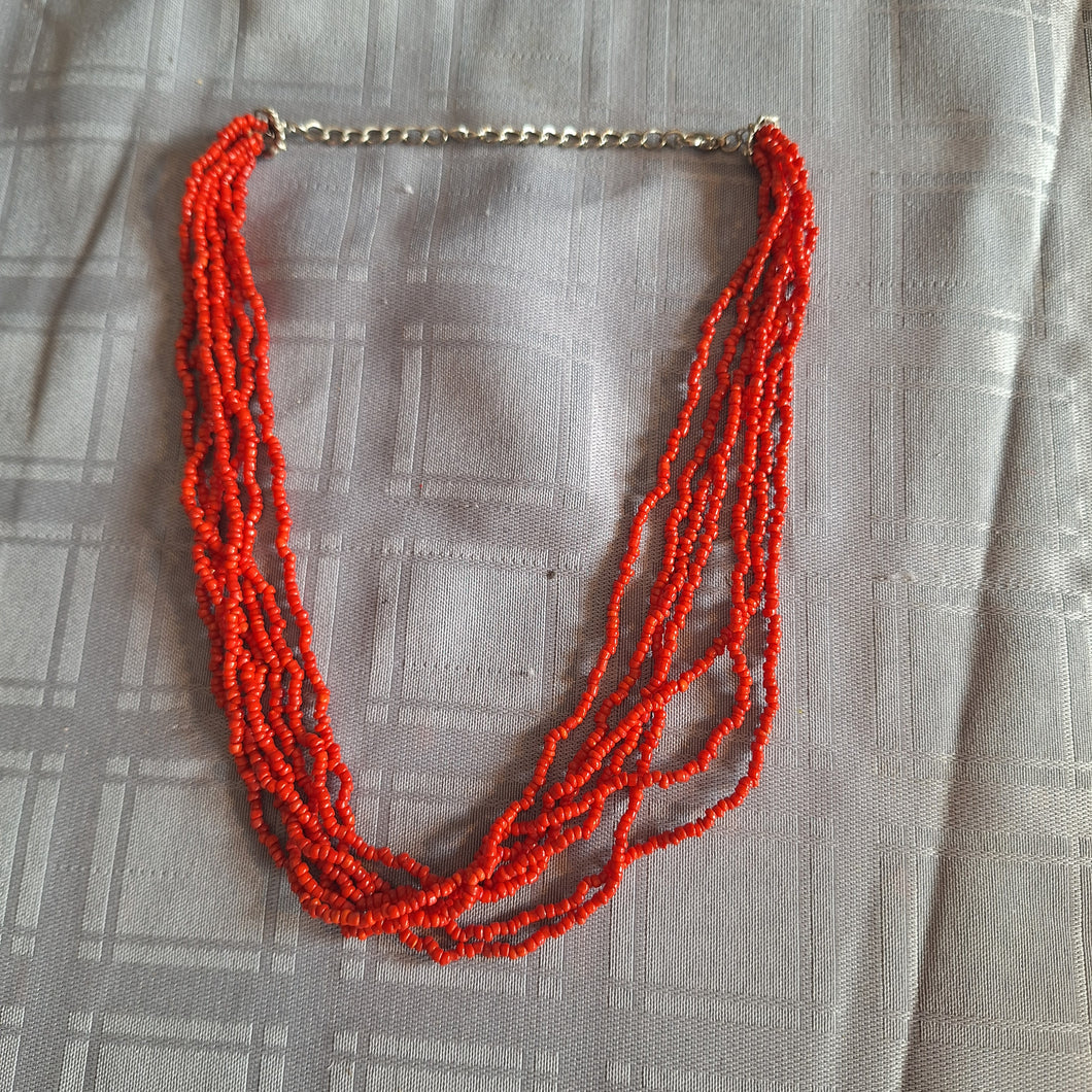 7 STRAND RED SEED BEAD NECKLACE.           18