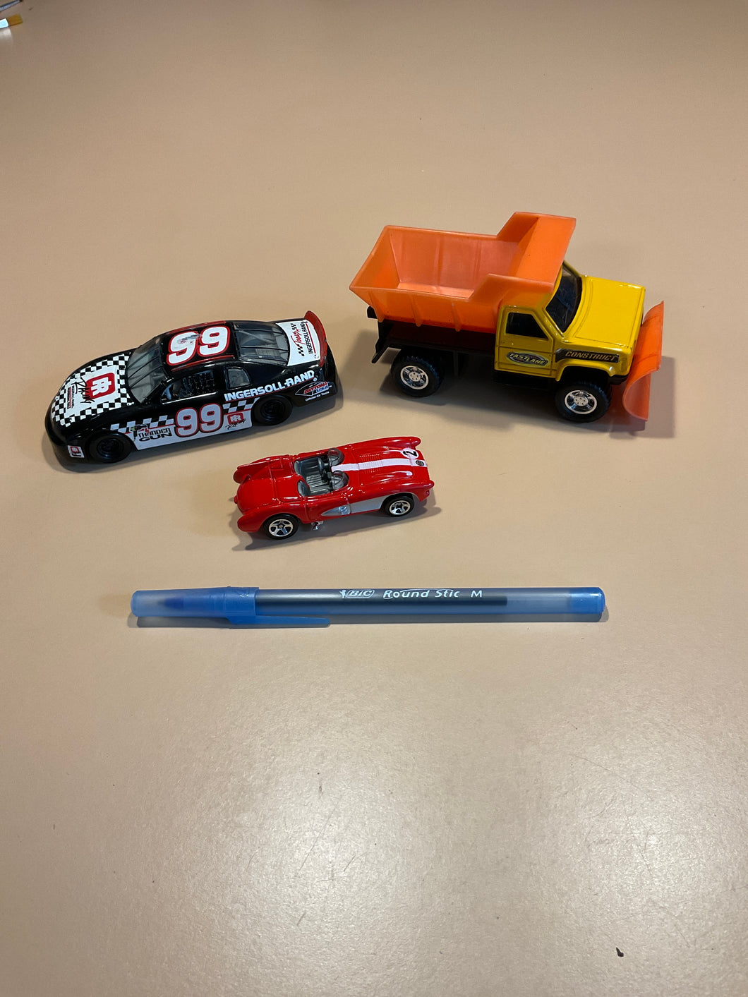 Toy snowplow & racecars Vehicles (pen for scale)