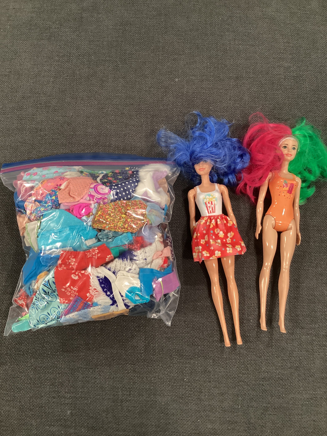 2 dolls & bag of clothes Bag is gallon size
