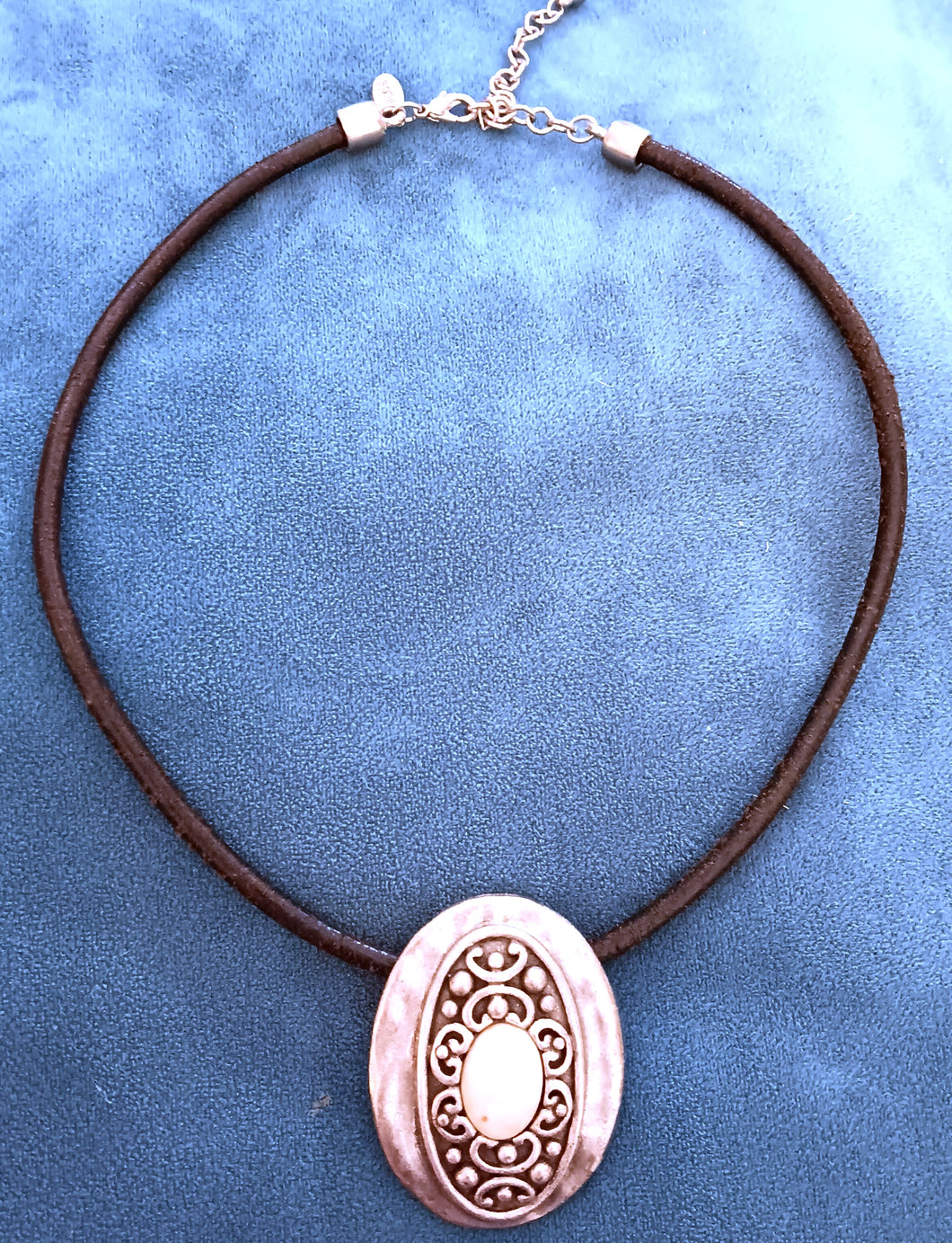 Metal pendant on leather style necklace